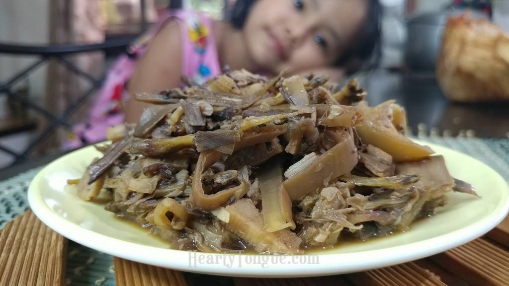 Child lovingly looks at adobong puso ng saging