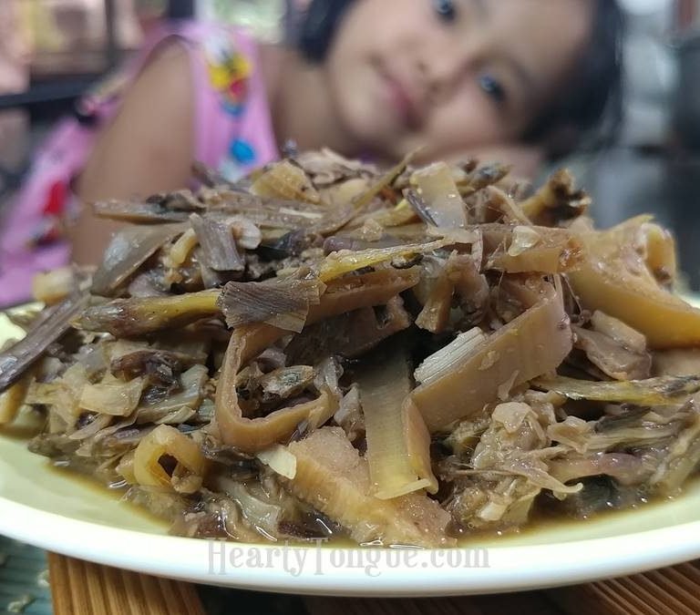 Child Lovingly Looks At Adobong Puso Ng Saging